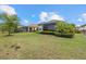 Backyard featuring a manicured lawn, complemented by elegant landscaping and patio at 12659 Sorrento Way, Bradenton, FL 34211