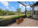 Enclosed outdoor patio with views of the landscaped backyard and surrounding greenery at 12659 Sorrento Way, Bradenton, FL 34211