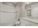 Bright bathroom with a white tiled shower-tub combination and granite countertop at 12659 Sorrento Way, Bradenton, FL 34211