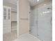 Bathroom featuring a glass-enclosed shower, tiled walls, and access to walk-in closet at 12659 Sorrento Way, Bradenton, FL 34211