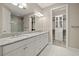 Bright bathroom with double vanity, granite countertops, and glass enclosed shower at 12659 Sorrento Way, Bradenton, FL 34211