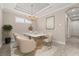Elegant dining room with modern chandelier, neutral decor and tile flooring at 12659 Sorrento Way, Bradenton, FL 34211