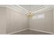 Dining room showcasing a statement chandelier, neutral walls, and tile flooring at 12659 Sorrento Way, Bradenton, FL 34211