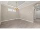 Dining room featuring a decorative chandelier and neutral walls with accent trim at 12659 Sorrento Way, Bradenton, FL 34211
