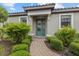 Inviting front entrance with a glass paneled door, flanked by manicured greenery at 12659 Sorrento Way, Bradenton, FL 34211
