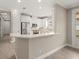 Modern kitchen with white cabinetry, stainless steel appliances, and a breakfast bar at 12659 Sorrento Way, Bradenton, FL 34211