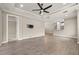 Spacious living room showing TV mount, with open access to the kitchen and hallway at 12659 Sorrento Way, Bradenton, FL 34211