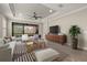 Bright living room features tray ceiling, fan, sleek furniture, and backyard access at 12659 Sorrento Way, Bradenton, FL 34211