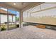 Outdoor oasis featuring a screened-in patio, brick floor, and retractable shade screen at 12659 Sorrento Way, Bradenton, FL 34211