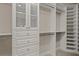 Walk-in closet featuring shelves, drawers, cabinets, and carpeted floor at 12659 Sorrento Way, Bradenton, FL 34211
