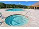 Exterior view of the community pool and hot tub with chair lift for assistance at 13105 Peregrin Cir, Bradenton, FL 34212