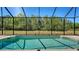 Inviting screened-in pool with lush green views provides a private outdoor retreat at 13105 Peregrin Cir, Bradenton, FL 34212