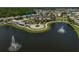 An aerial view of a community clubhouse, lake, and amenities, showcasing a desirable lifestyle at 15408 Trinity Fall Way, Bradenton, FL 34212