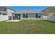 Backyard view of home showing the screened patio and lawn at 15408 Trinity Fall Way, Bradenton, FL 34212