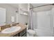 Clean bathroom featuring a granite vanity top, a large mirror, shelves, and a shower-tub combination at 15408 Trinity Fall Way, Bradenton, FL 34212