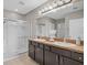 Bathroom with a double vanity, walk-in shower, and modern fixtures at 15408 Trinity Fall Way, Bradenton, FL 34212