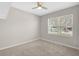Bedroom featuring neutral walls, carpet, a ceiling fan and a window at 15408 Trinity Fall Way, Bradenton, FL 34212