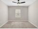 Bedroom with neutral walls, carpet, a ceiling fan and a window with blinds at 15408 Trinity Fall Way, Bradenton, FL 34212