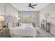 Bedroom featuring a tufted headboard, soft bedding, and a window offering natural light at 15408 Trinity Fall Way, Bradenton, FL 34212