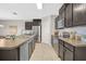 Spacious kitchen with stainless steel appliances, large sink, and dark wooden cabinets at 15408 Trinity Fall Way, Bradenton, FL 34212