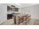 Modern kitchen with center island, stainless steel appliances, and dark cabinetry at 15408 Trinity Fall Way, Bradenton, FL 34212