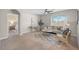 Bright living room with modern furnishings, neutral tones, and an open doorway to the bedroom at 15408 Trinity Fall Way, Bradenton, FL 34212