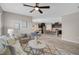 Open-concept living room with neutral decor and a view into the kitchen and dining area at 15408 Trinity Fall Way, Bradenton, FL 34212