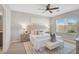 Serene main bedroom with a large window, plush bedding, and soft lighting at 15408 Trinity Fall Way, Bradenton, FL 34212