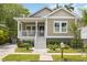 Charming home with a welcoming front porch, well-manicured lawn, and lush landscaping at 1623 8Th W Ave, Bradenton, FL 34205