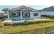 Inviting backyard with pool, spa, covered patio, and lush greenery perfect for outdoor relaxation and entertaining at 1702 4Th St E E St, Palmetto, FL 34221