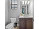 Powder room featuring a modern vanity, white countertop, stylish fixtures, and window with blinds at 1702 4Th St E E St, Palmetto, FL 34221