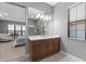 Bathroom with wooden vanity, white countertop, large mirror and walk-in shower at 1702 4Th St E E St, Palmetto, FL 34221