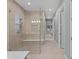 Large bathroom with walk-in shower, bench, modern fixtures, neutral tile, and glass door at 1702 4Th St E E St, Palmetto, FL 34221