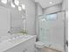 Bright bathroom features white vanity, walk-in shower, and tile flooring at 1702 4Th St E E St, Palmetto, FL 34221