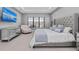 Bright main bedroom with water view, a mirrored dresser, tufted headboard, and cozy seating at 1702 4Th St E E St, Palmetto, FL 34221