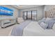 Bright main bedroom with water view, a mirrored dresser, tufted headboard, and cozy seating at 1702 4Th St E E St, Palmetto, FL 34221