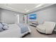 Bright main bedroom with water view, mirrored dresser, comfortable chair, and tray ceiling at 1702 4Th St E E St, Palmetto, FL 34221
