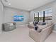 Bonus room with TV and comfortable seating has a large window overlooking the water at 1702 4Th St E E St, Palmetto, FL 34221