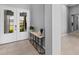 Bright entryway with double doors, decorative table, and neutral-toned tile flooring, offering a welcoming feel at 1702 4Th St E E St, Palmetto, FL 34221