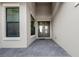 Inviting front porch with double doors, neutral colors, and brick floor at 1702 4Th St E E St, Palmetto, FL 34221