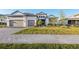 Charming two-story home with a well manicured lawn, brick driveway, and a three car garage at 1702 4Th St E E St, Palmetto, FL 34221