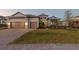 Charming two-story home with a well manicured lawn, brick driveway, and a three car garage at 1702 4Th St E E St, Palmetto, FL 34221