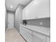 Hallway with storage, white cabinets and countertops, tile floor and gray walls at 1702 4Th St E E St, Palmetto, FL 34221