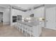 Modern kitchen with white cabinets, stainless steel appliances, large island with seating and a view of living space at 1702 4Th St E E St, Palmetto, FL 34221
