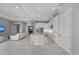 Open-concept kitchen featuring white cabinetry, a central island with bar seating, and modern stainless steel appliances at 1702 4Th St E E St, Palmetto, FL 34221