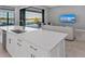 Kitchen island features white cabinets, stainless dishwasher and undermount sink with modern faucet at 1702 4Th St E E St, Palmetto, FL 34221