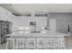 Bright, modern kitchen features sleek white cabinets, stainless steel appliances, and a large island with bar seating at 1702 4Th St E E St, Palmetto, FL 34221