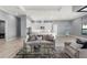 Spacious living area with gray walls, white trim and cabinets, and modern furniture; seamlessly integrates with kitchen at 1702 4Th St E E St, Palmetto, FL 34221