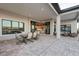 Elegant outdoor living area with covered patio, dining set, and seamless access to the interior at 1702 4Th St E E St, Palmetto, FL 34221