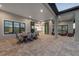 Elegant outdoor living area with covered patio, dining set, and seamless access to the interior at 1702 4Th St E E St, Palmetto, FL 34221